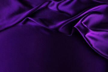 Purple satin background. Soft folds on shiny fabric. Luxurious backdrop with space for design. Flat lay, top view.