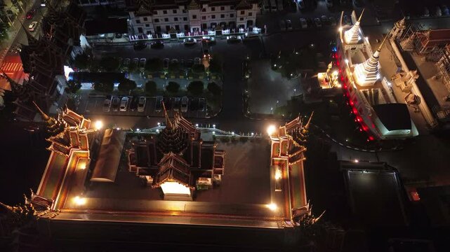 Aerial view of the Wat Yan Nawa temple in Sathon at night in the city of Bangkok, Thailand, 4k