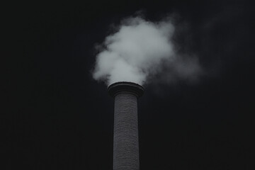 Smoke Stack Emission: A towering smoke stack emits a cloud of thick, billowing smoke against a dark background, symbolizing the impact of industrial processes on the environment.