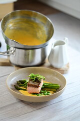 A close-up of the preparation process for hollandaise sauce, Culinary Process in a Silver Mixing Bowl