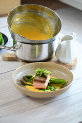 A close-up of the preparation process for hollandaise sauce, Culinary Process in a Silver Mixing Bowl