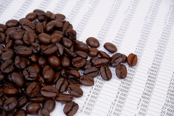 Roasted coffee beans on financial paper. Coffee prices concept.