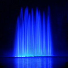 Blue water fountain display at night; event backdrop