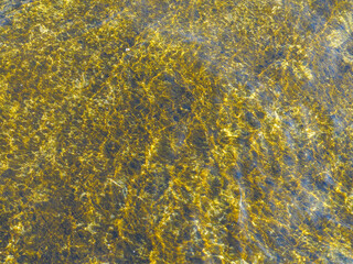 Abstract image formed by a water surface with reflections.