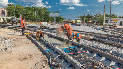 Pouring ready-mixed concrete after placing steel reinforcement to make the road by concrete mixer...