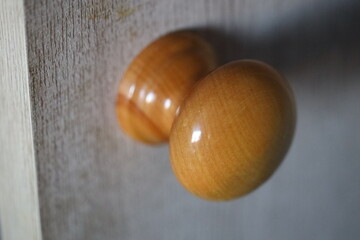 A close-up view of two wooden door knobs.