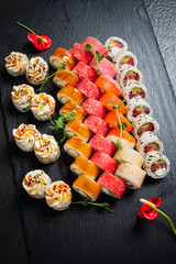 A vibrant sushi platter displays a variety of rolls and garnishes, inviting a taste adventure