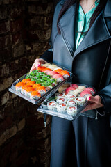 Vibrant sushi rolls in two containers highlight fresh ingredients and colors