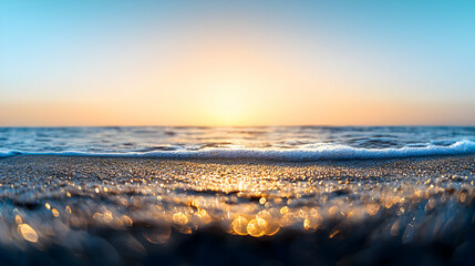 Naklejka premium Golden Sunrise Over Ocean Waves with Sparkling Sand and Tranquil Blue Sky Seascape Photography
