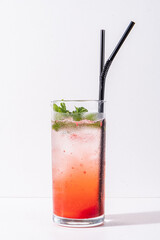 A vibrant layered drink filled with mint leaves and ice offers a refreshing delight
