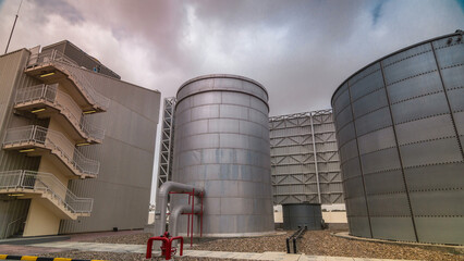 Two silver Water Tanks with fence timelapse hyperlapse