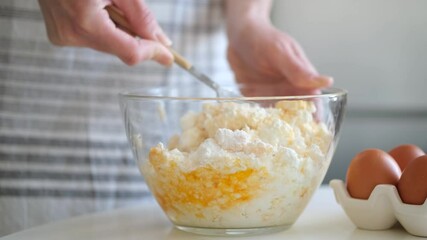 Housewife mixing cake dough in bowl. Preparing cottage cheese cake or syrniki