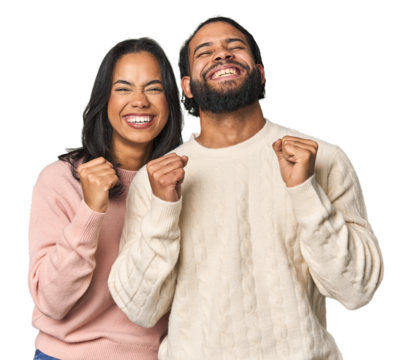 Young Latino couple in studio celebrating a victory, passion and enthusiasm, happy expression.