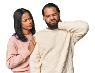 Young Latino couple in studio having a neck pain due to stress, massaging and touching it with hand.
