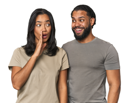 Young Latino couple in studio is saying a secret hot braking news and looking aside