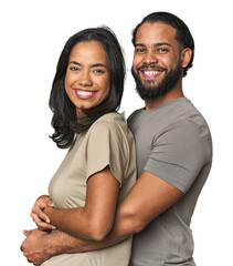 Latino couple in love embracing warmly in studio