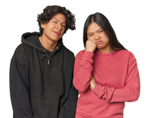 Young interracial couple in studio who feels sad and pensive, looking at copy space.