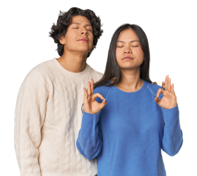 Young interracial couple in studio relaxes after hard working day, she is performing yoga.