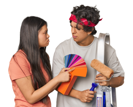 Happy multiracial couple with painting tools in studio