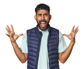 Young Hispanic man isolated screaming to the sky, looking up, frustrated.