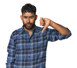Young Hispanic man isolated showing thumb down, disappointment concept.