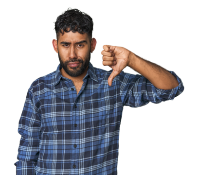 Young Hispanic man isolated showing thumb down, disappointment concept.