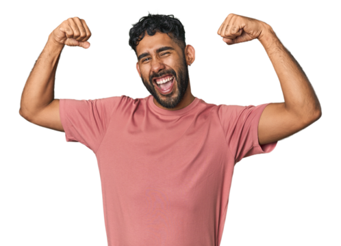 Young Hispanic man isolated showing strength gesture with arms, symbol of feminine power