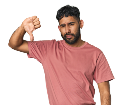 Young Hispanic man isolated showing thumb down, disappointment concept.
