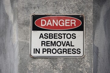 Danger Asbestos Removal in Progress Sign on Wall