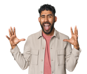 Young Hispanic man isolated screaming to the sky, looking up, frustrated.