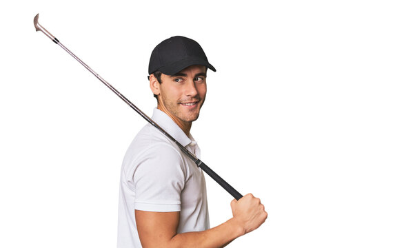 Young Hispanic man with golf club looks aside smiling, cheerful and pleasant.