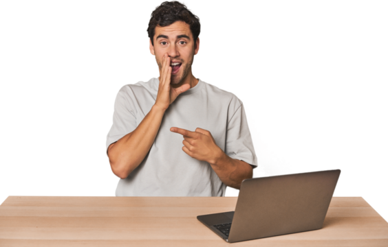 Hispanic young man working on laptop saying a gossip, pointing to side reporting something. - Powered by Adobe