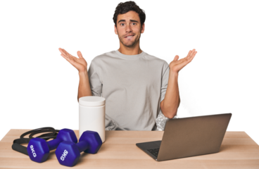 Hispanic trainer planning workout confused and doubtful shrugging shoulders to hold a copy space.