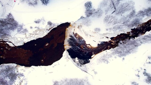 aerial view of winter river and waterfall