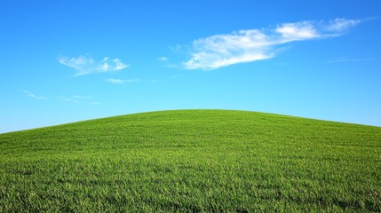Naklejka premium Green Grass Hill Under Blue Sky with White Clouds Scenery