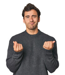 Young Hispanic man in studio showing that she has no money.