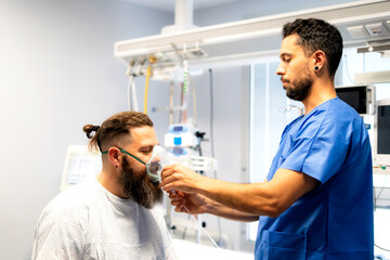 Nurse placing oxygen mask on patient in hospital room