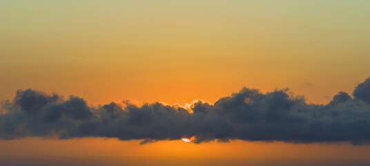Obraz premium Amazing sunset skyscape. Evening sky with bright colorful orange and yellow clouds