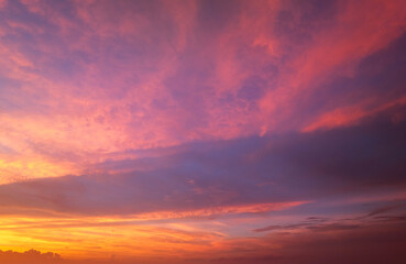 Amazing sunset skyscape. Evening sky with bright colorful orange and yellow clouds