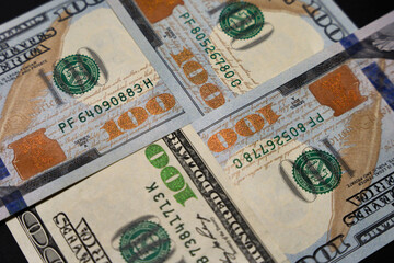 $100 bills joined at the corners