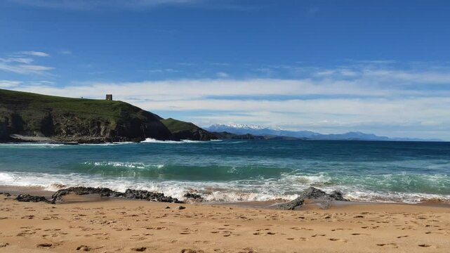Snowy Picos de Europa from Tagle Beach, Cantabria - Majestic snowy peaks of Picos de Europa viewed from Tagle Beach, Cantabria, with the Cantabrian Sea in the foreground.