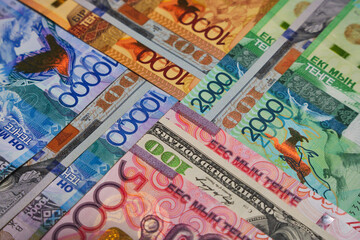 Tenge banknotes of different denominations and dollars in the form of a cross