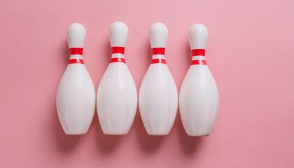 Naklejka premium White bowling pins on pink background. Sport, leisure and competition theme.