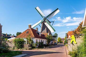 A classic Dutch windmill in the charming village of Woudsend, Friesland, Netherlands.