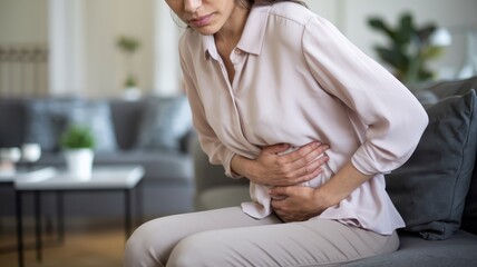 Woman Experiencing Abdominal Pain at Home