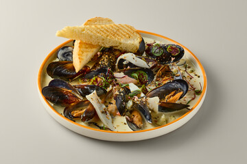 Elegant Culinary Presentation of Mussels in Cream Sauce with Sophisticated Styling and Lighting
