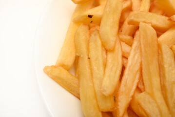 Fried potato. French fries on a white plate. Fast food.