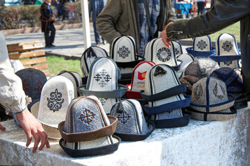 Ak-Kalpak, Kyrgyz men's national headdress, textile material made from felted wool. Outdoor market