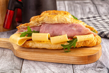 Fresh croissant with ham and cheese