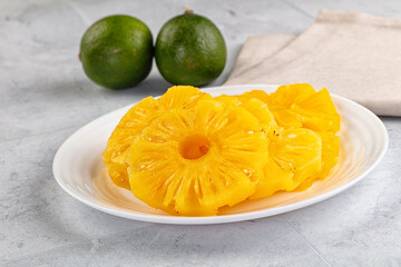 Sweet canned pineapple slices in syrope